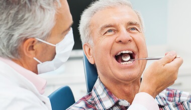 Dentist examining smile before periodontal therapy